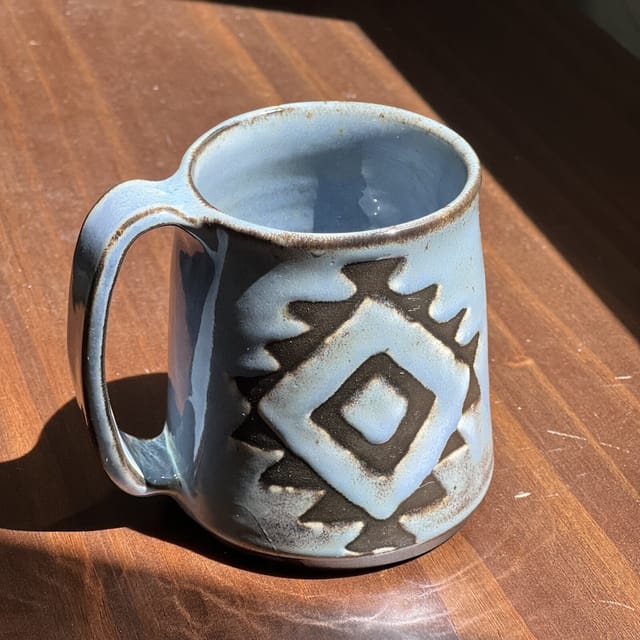 High Desert Diamond Mug — A hand-carved southwestern diamond through dark slip under river-blue glaze