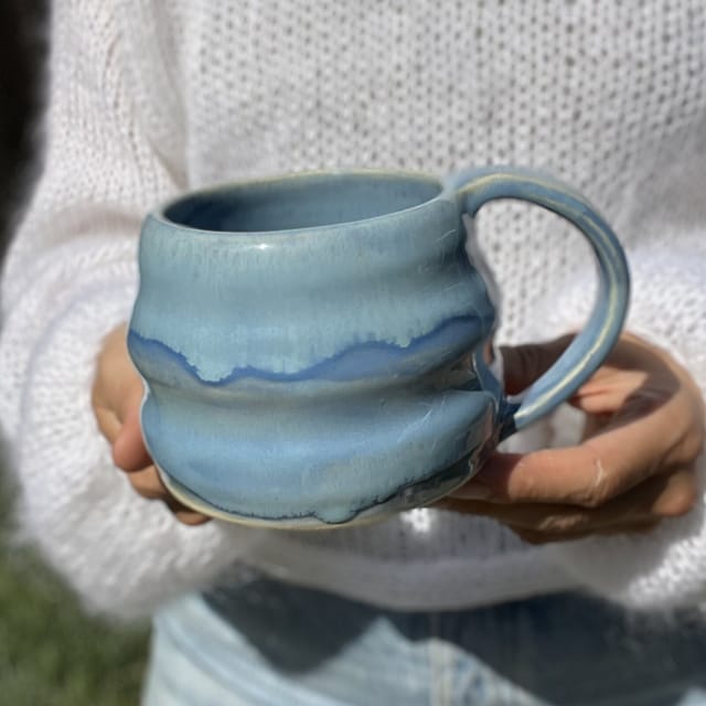 River Wave Mug — A wobbly, wavy mug in river blue — altered by hand while still wet